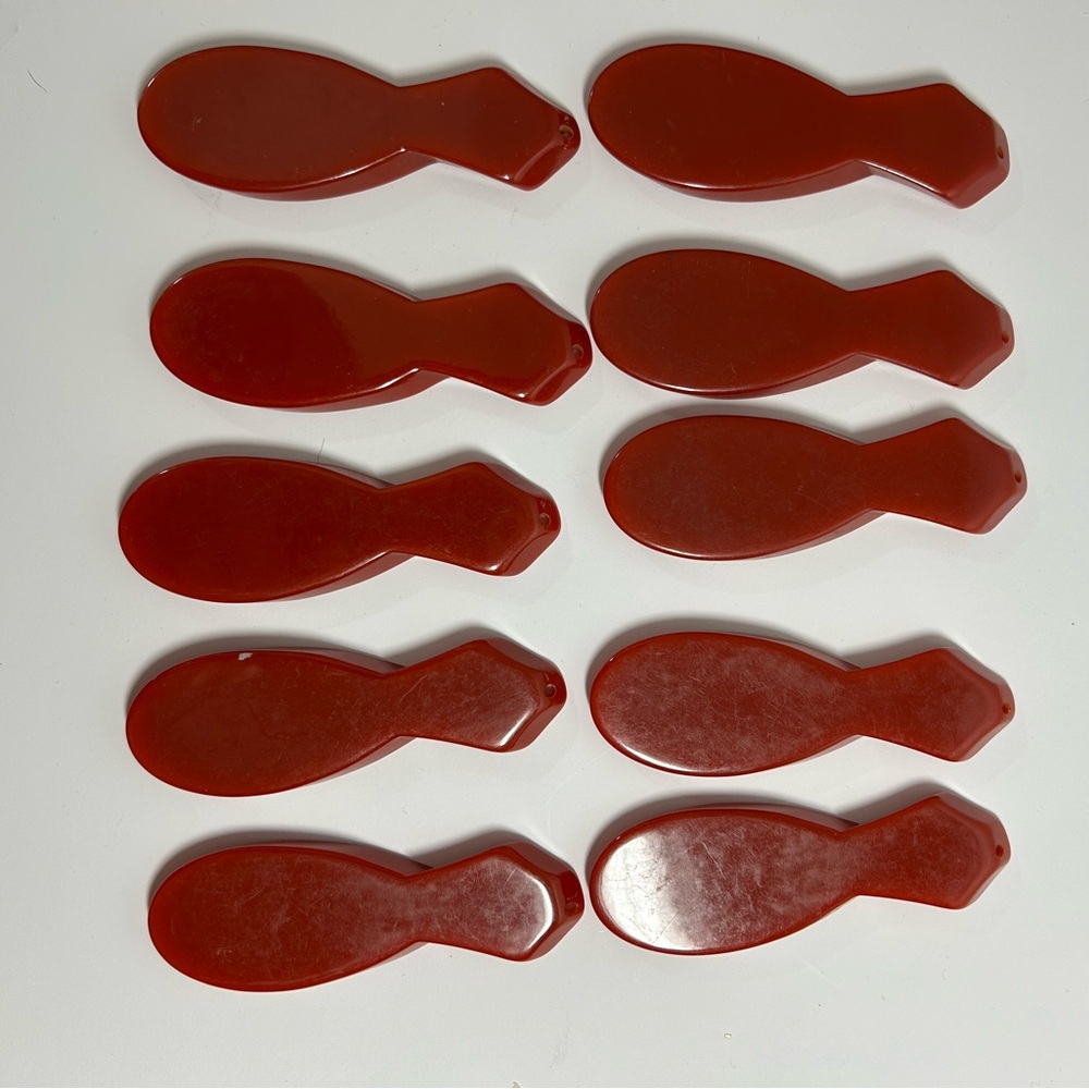 Lot of rust colored Bakelite unique shapes with drilled holes